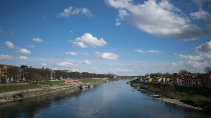 View from the covered bridge of Pavia - View on river with blue and cloudy sky