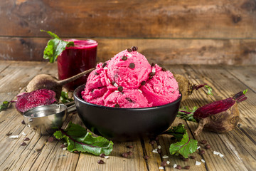 Obraz na płótnie Canvas Vegan diet food concept. Healthy beet root ice cream with chocolate drops, rustic wooden background copy space