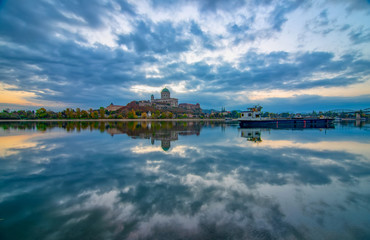 Fototapeta premium Amazing sunrise view over Danube river, beautiful reflections of morning clouds mirrored in water, Esztergom, Hungary