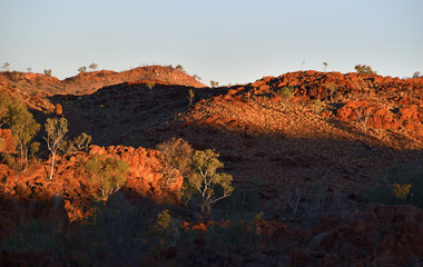 Undulating rocky hills sunbaked at sunset in outback Western Australia.