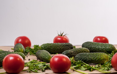 Organic vegetables tomatoes cucumbers parsley over craft paper. Zero waste, plastic free concept. Healthy clean eating diet and detox. Top view, flat lay. Veggie ingredients for cooking.