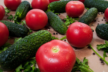 Organic vegetables tomatoes cucumbers parsley over craft paper. Zero waste, plastic free concept. Healthy clean eating diet and detox. Top view, flat lay. Veggie ingredients for cooking.
