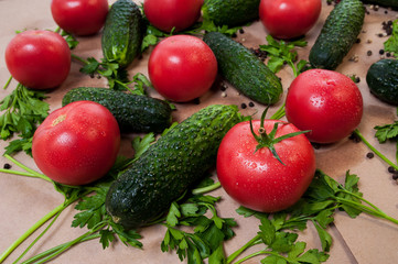 Organic vegetables tomatoes cucumbers parsley over craft paper. Zero waste, plastic free concept. Healthy clean eating diet and detox. Top view, flat lay. Veggie ingredients for cooking.