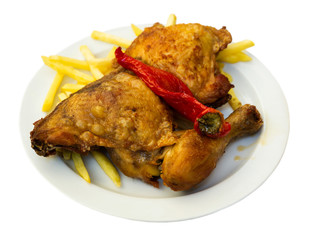 Tasty baked chicken and red paprika with french fries at plate