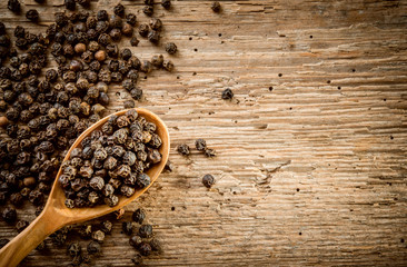 Peppercorn background. Dry black pepper seeds. Top view. Flat design.
