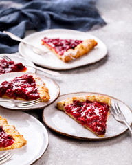 Bakery products. Summer pie with berries. Galeta with cherries sprinkled with powdered sugar.