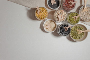 Assortment of beans and lentils in wooden bowl and spoon on clear background. mung bean, groundnut,...