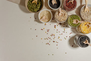 Assortment of beans and lentils in wooden bowl and spoon on clear background. mung bean, groundnut,...