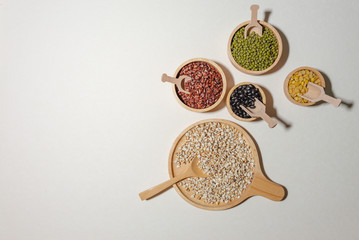 Assortment of beans and lentils in wooden bowl and spoon on clear background. mung bean, groundnut,...