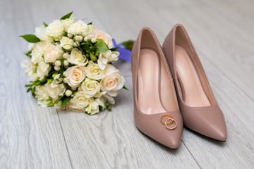 wedding rings on the bride's shoes. Wedding. Decor. Bride's shoes. Wedding bride's shoes and rings. Wedding white shoes