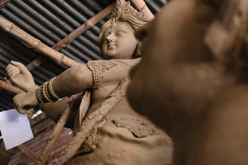 Clay idol of Goddess Devi Durga is in preparation for the upcoming Durga Puja festival at a pottery studio in Krishnanagar, West Bengal, India.
