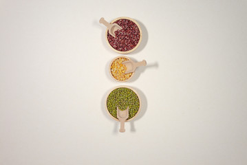 Assortment of beans and lentils in wooden bowl and spoon on clear background. mung bean, groundnut,...