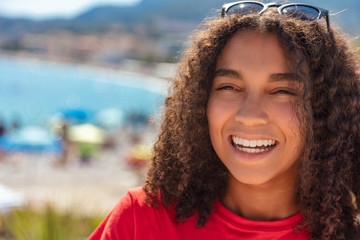 Mixed Race African American Girl Teenager Laughing By Beach