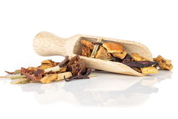 Lot of pieces of lingonberry strawberry fruit tea with wooden scoop isolated on white background