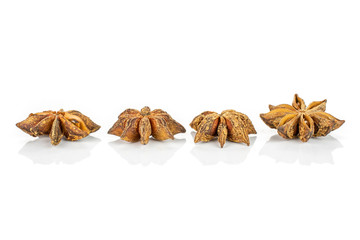 Group of four whole dry brown star anise illicium verum isolated on white background