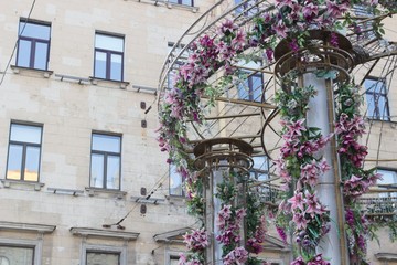 Flower arch on the background of the building