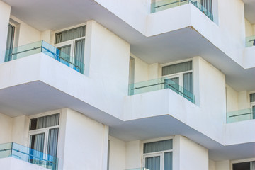 Fototapeta na wymiar white building exterior facade with balcony and windows 