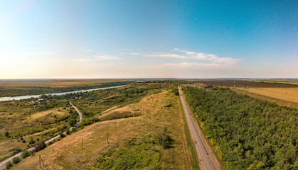 Fototapeta na wymiar rural landscape with a road and a river. Aerial view (drone view) on a summer day in August above the right bank of the Don River near the place 
