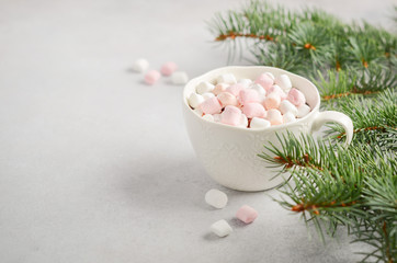 Cup of hot chocolate with marshmallows on a gray concrete background. Christmas concept.