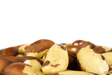 Lot of whole raw brown brazil nut isolated on white background