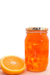 Fototapeta na wymiar Oranges with a bottle of marmalade, against white isloated background