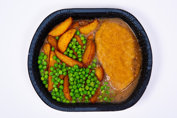 Freezer meal with peas, potatoes and wiener schnitzel.