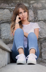 young woman sitting on a bench