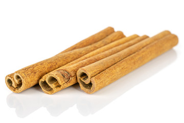 Group of three whole dry brown cinnamon isolated on white background