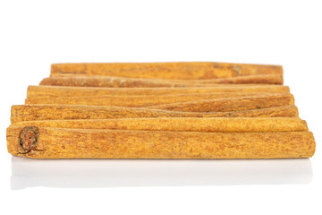 Lot of whole dry brown cinnamon isolated on white background