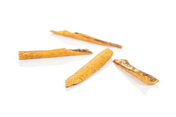 Group of four pieces of dry brown cinnamon isolated on white background