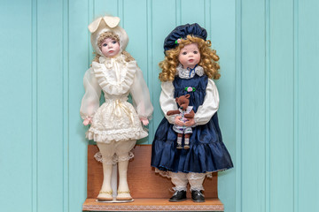 Fototapeta na wymiar A doll in a bunny suit and a doll in a blue dress and blue cap
