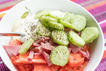 Salad of cucumbers, tomatoes, delicious beef, black pepper, salt, sour cream, mayonnaise. Do not mix salad