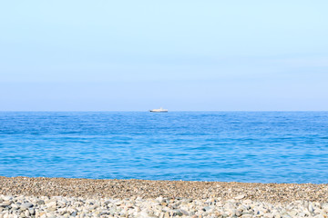 view of the beach, the sea and the ship on the horizon, background.