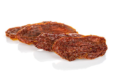 Group of four whole dried red tomato isolated on white background