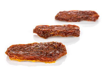 Group of three whole dried red tomato isolated on white background