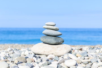 balance of stones on the background of the sea on the pebble plan, the concept of harmony and relaxation, close-up.