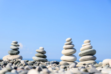 Fototapeta na wymiar balance of stones against the sea and sky, the concept of harmony and relaxation, close-up