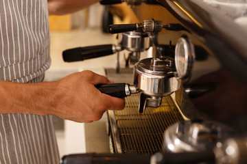Close up of barista making coffee for clients in the morning