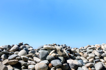 large pebbles and sky, background.