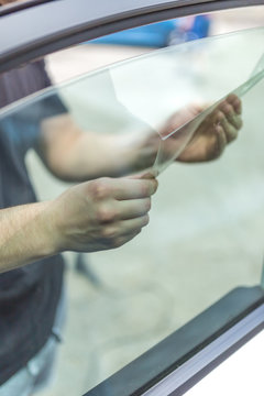 Process of removing sunlight protective car window glass foil.
