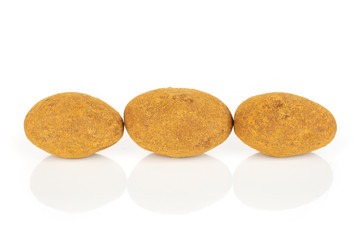 Group of three whole sweet brown chocolate cinnamon almond isolated on white background