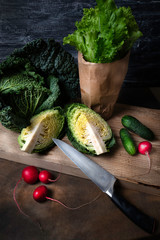 Savoy cabbage and other garden vegetables on an old board