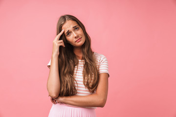 Sad negative girl posing isolated over pink wall background.