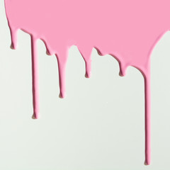 Pouring pink paint on white background. Creative pattern with copy space.