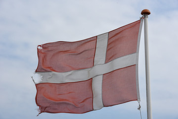 Denish flag waving against blue sky