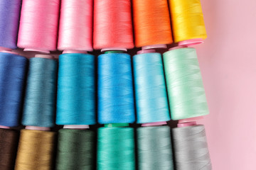 Accessories for sewing and needlework. Many multi-colored spools of thread. Bobbins with colored thread