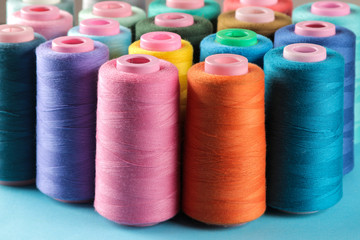 Accessories for sewing and needlework. Many multi-colored spools of thread. Bobbins with colored thread
