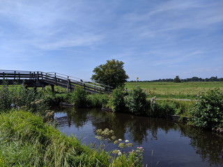 Fototapeta na wymiar Bridge over a canal around Zuideinde,