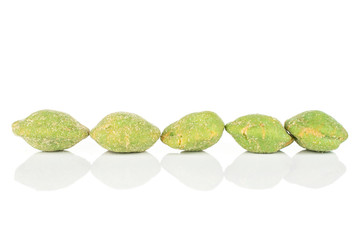 Group of five whole spicy green wasabi peanut isolated on white background