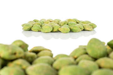 Lot of whole spicy green wasabi peanut part is in the back and part is in the front isolated on white background